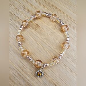 Beaded glass bracelet with sun charm